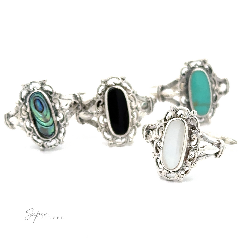 A set of four Inlaid Oval Rings with Filigree Heart Border, featuring vintage appeal.