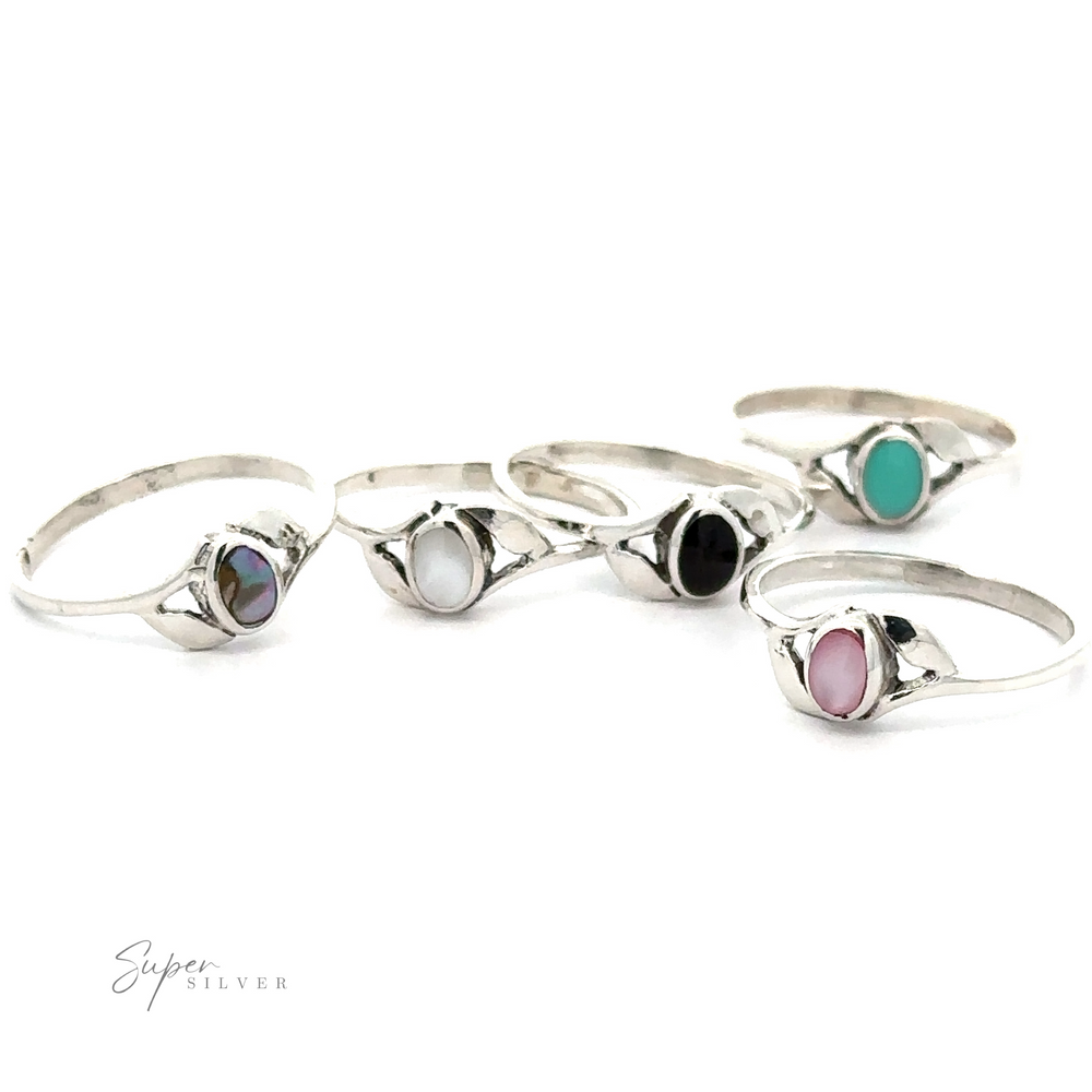 A collection of Dainty Oval Stone Rings with Leaf Accents displayed on a white background.