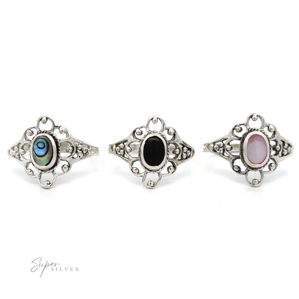 
                  
                    Three Vintage-Styled Flower Rings with Inlaid Stones, exuding vintage appeal, on a white background.
                  
                