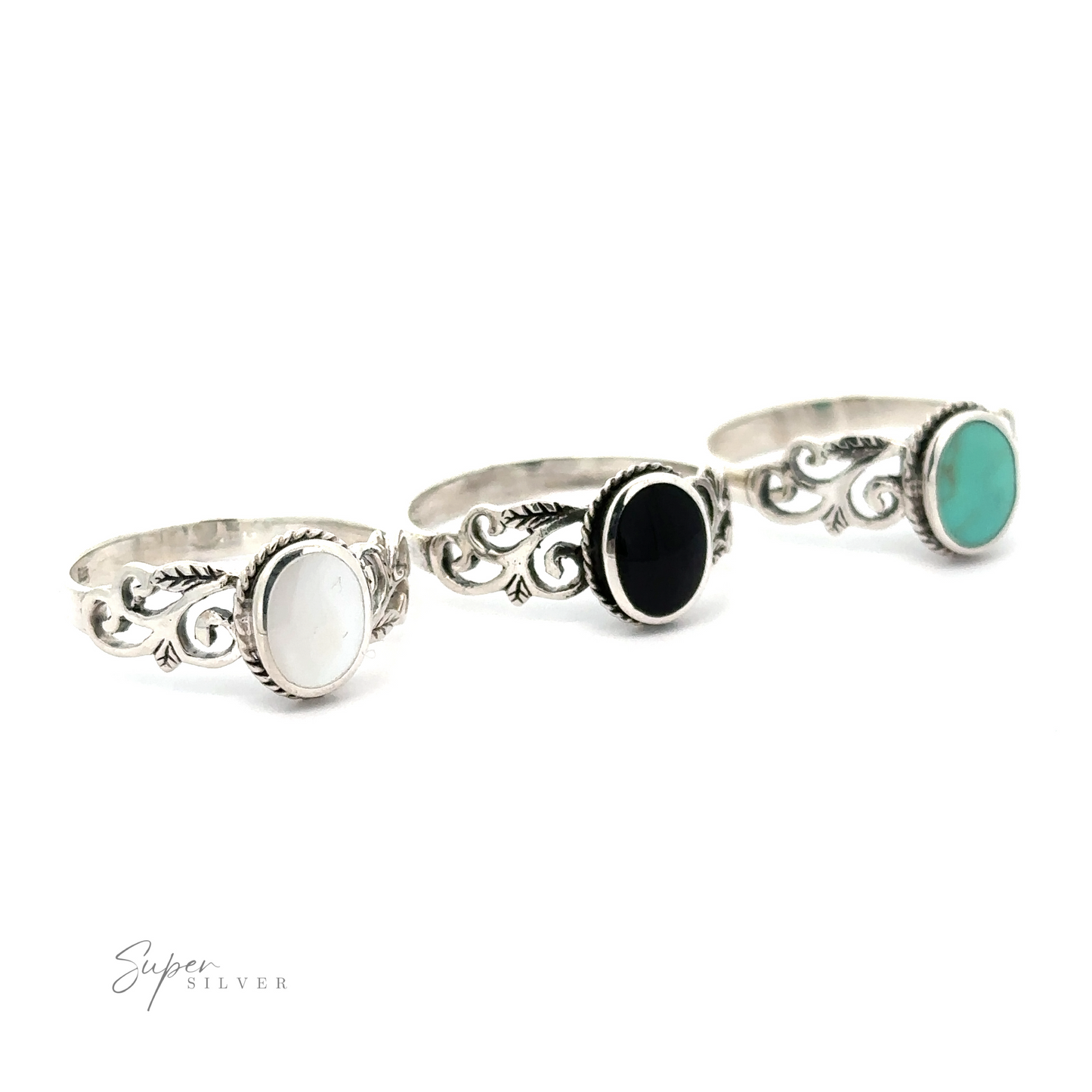 Three Oval Inlaid Rings with Swirls and Leaf Detailing featuring turquoise and black stones.