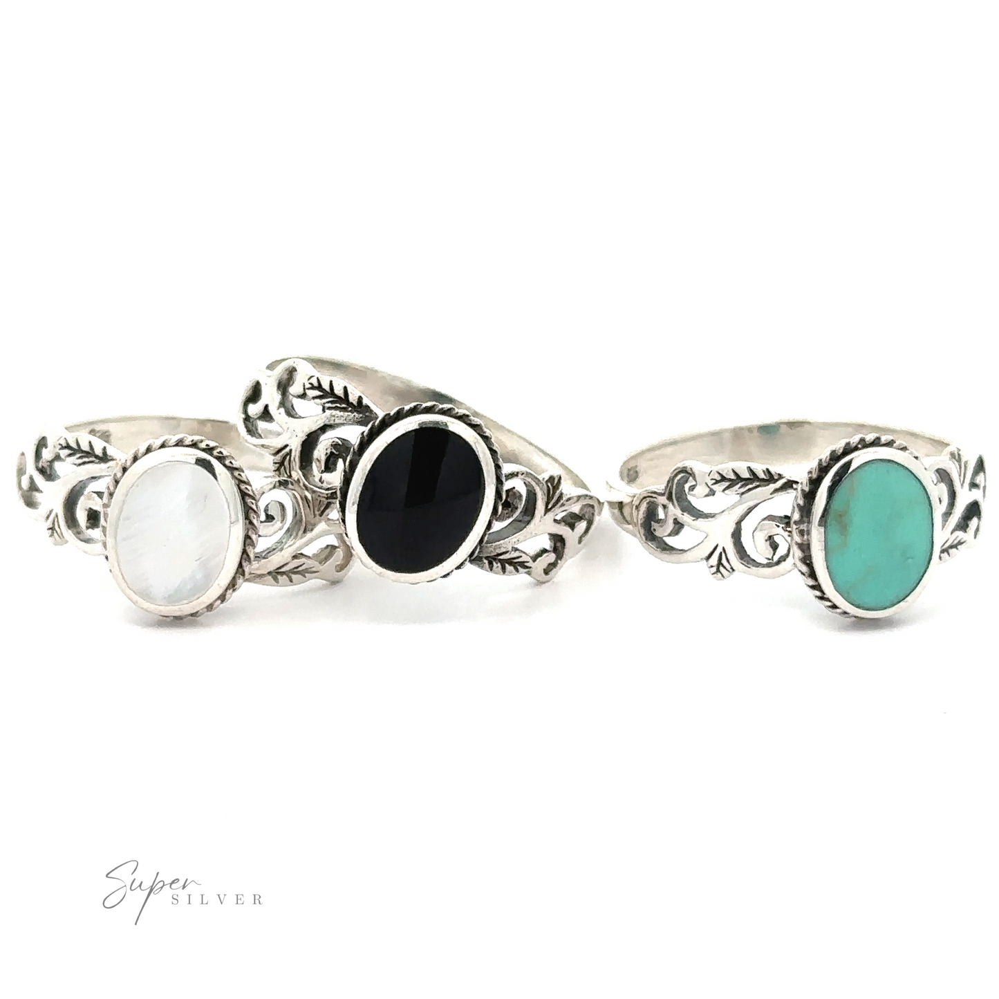 Three Oval Inlaid Rings with Swirls and Leaf Detailing featuring black and turquoise stones.