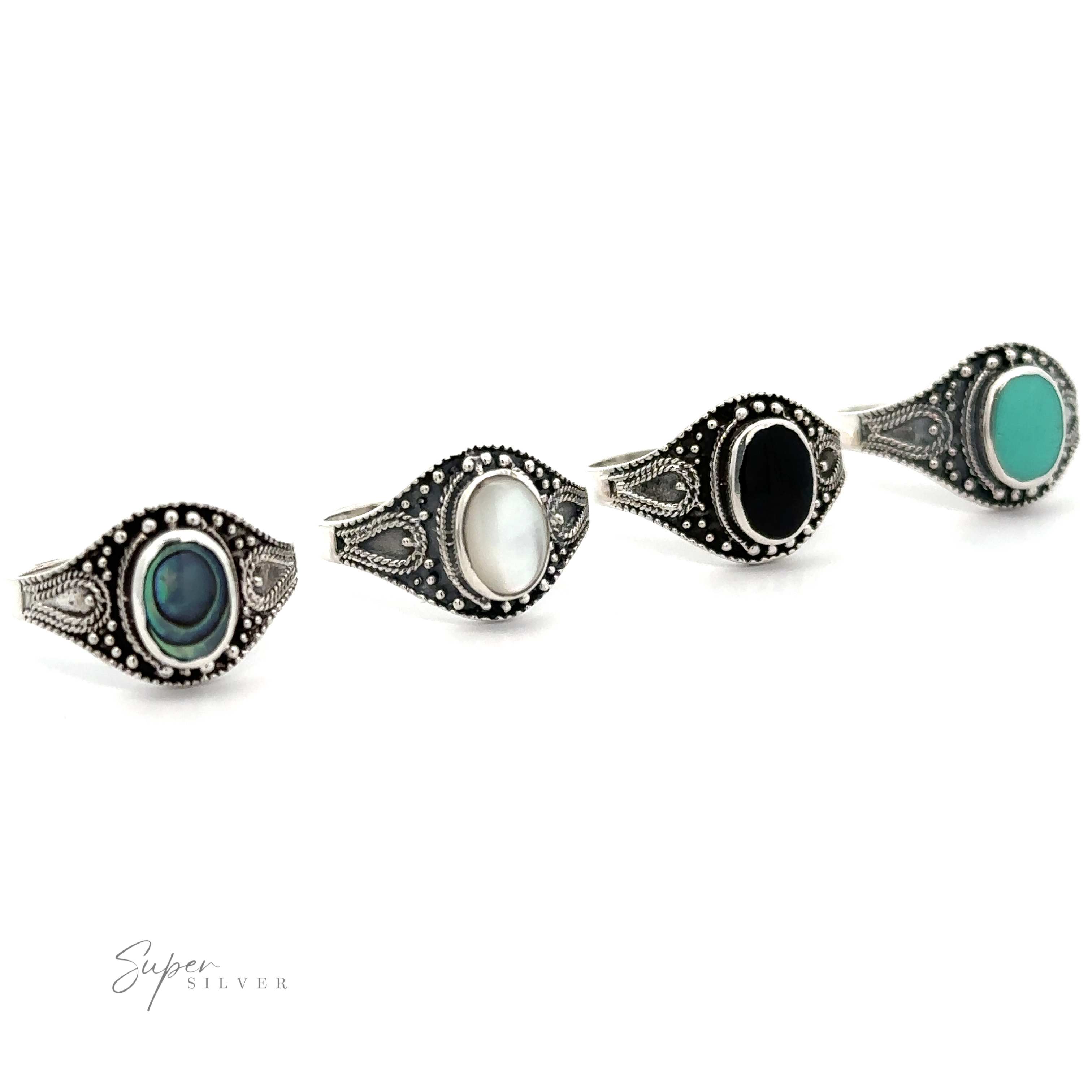 A set of Vintage Style Oval Shield Rings with Inlaid Stones and oxidized detailing.