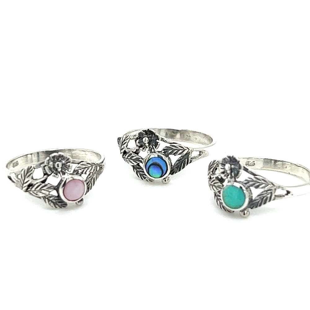 Three vintage-inspired Super Silver inlaid stone rings with dainty flower accents.