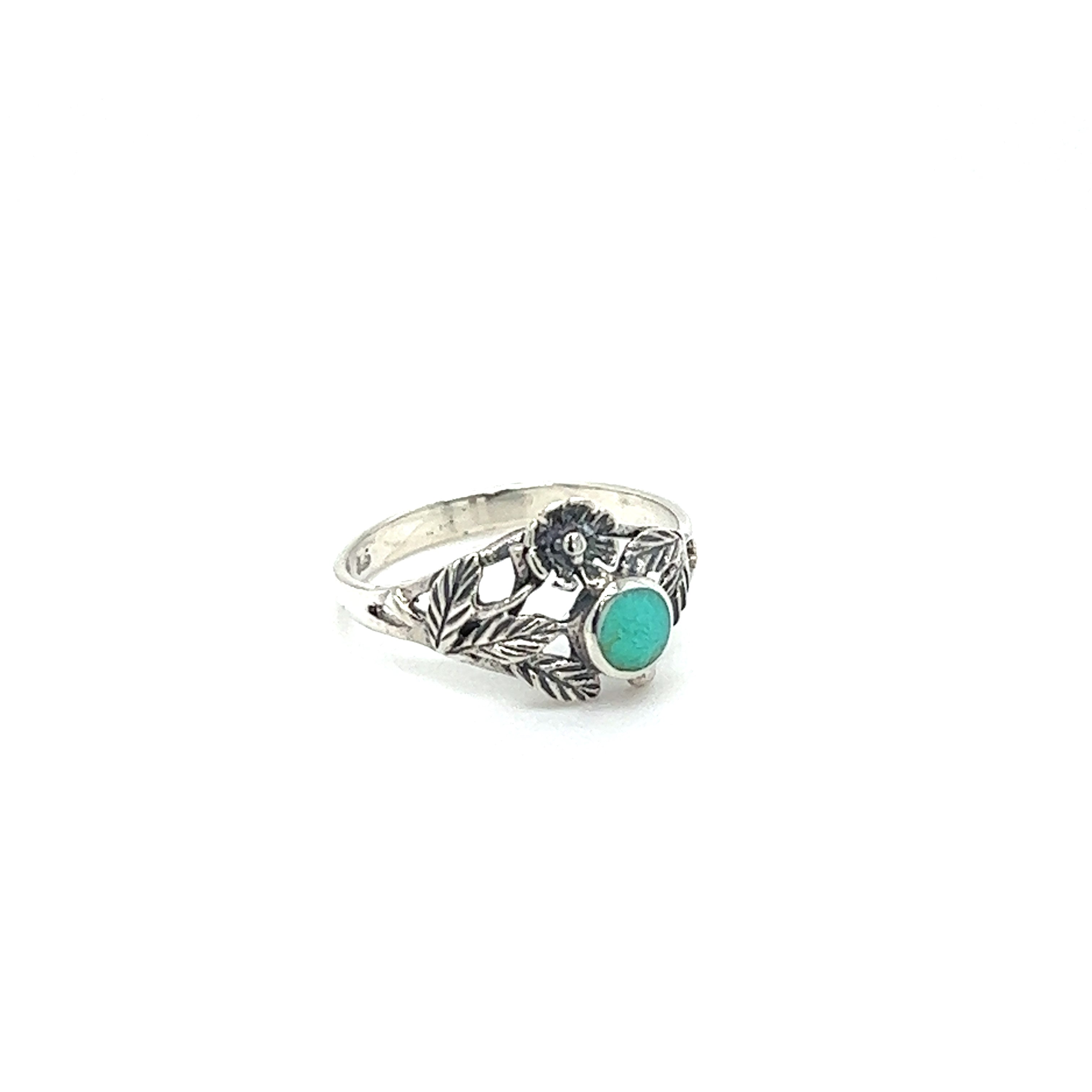 A vintage-inspired Super Silver Inlaid Stone Ring with Dainty Flower and an inlaid turquoise stone and black stones.