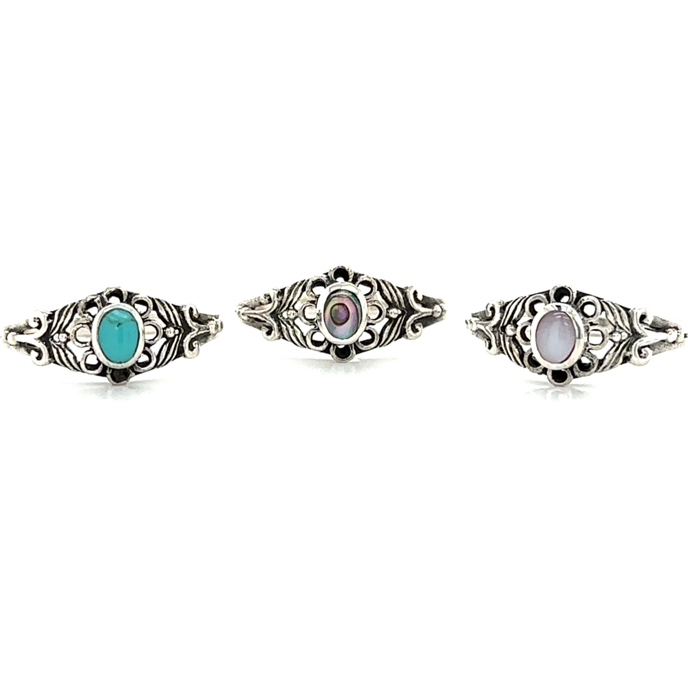 A set of three Oval Flower Rings with Inlay Stones in silver and turquoise.