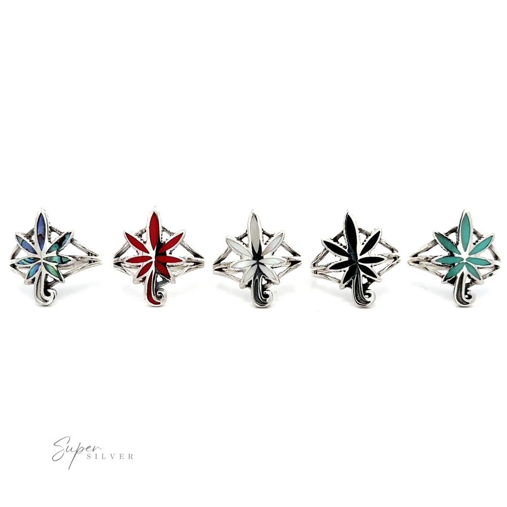 
                  
                    A set of five Inlay Stone Marijuana Leaf Rings with colorful designs.
                  
                