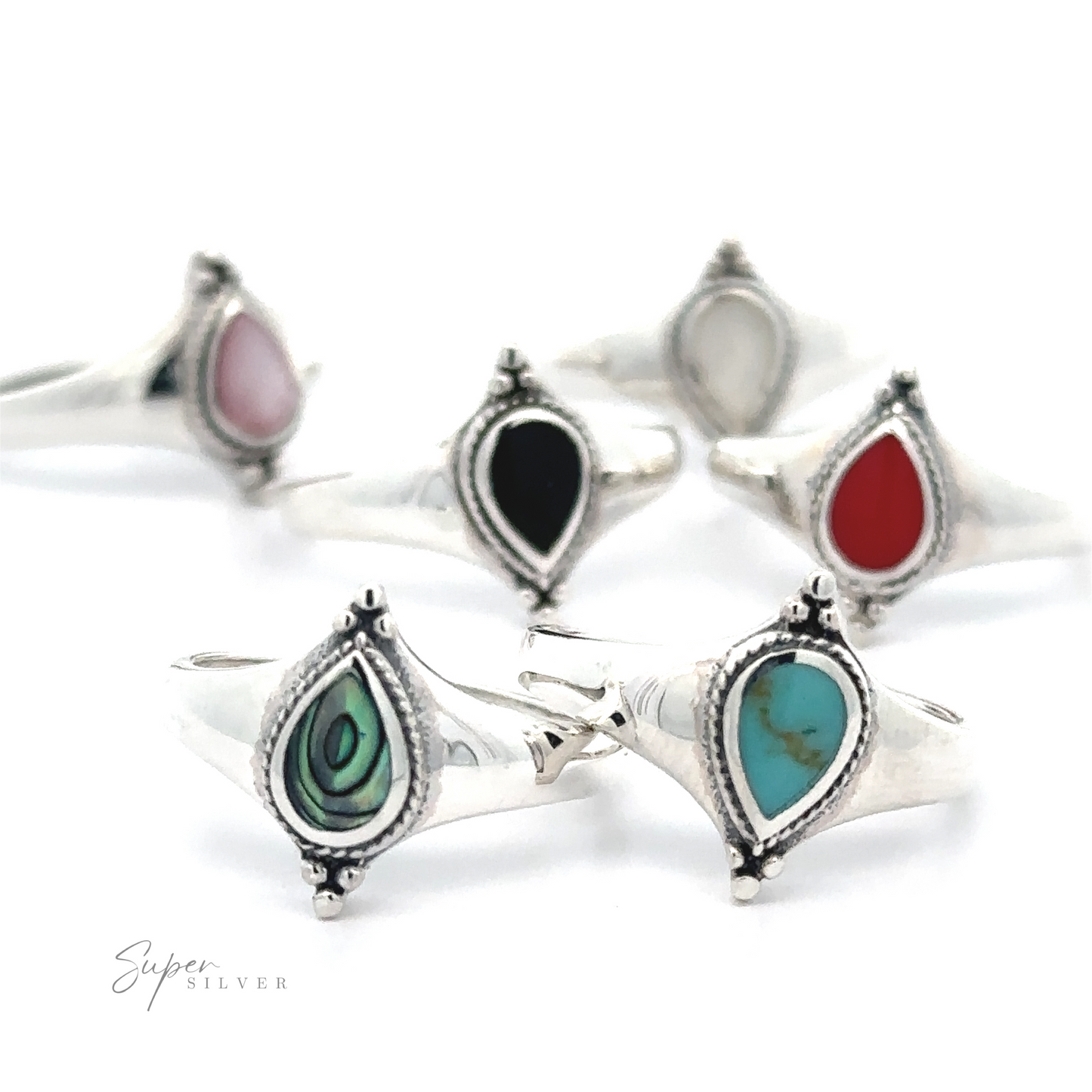 
                  
                    A collection of Teardrop Inlay Shield Rings with various colored gemstones.
                  
                