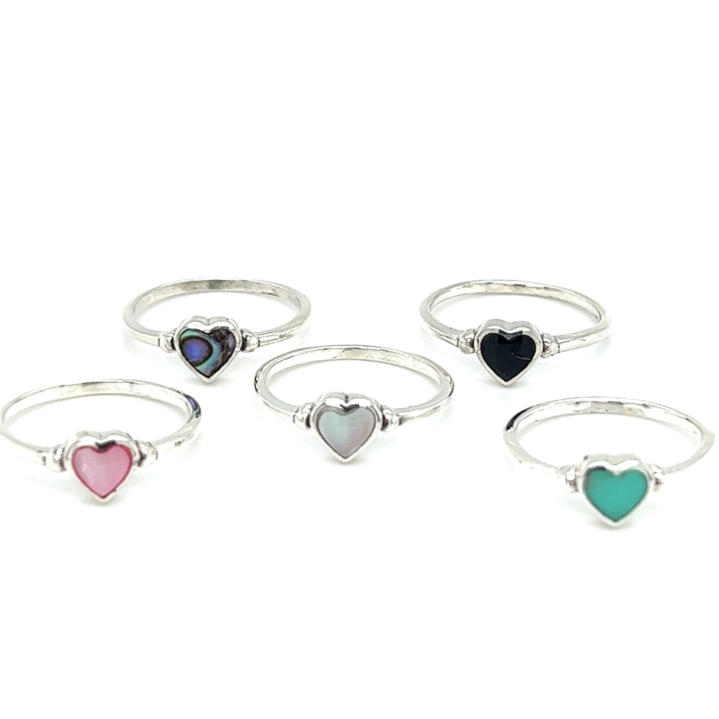 Four Dainty Inlaid Heart Rings with inlayed colored stones.