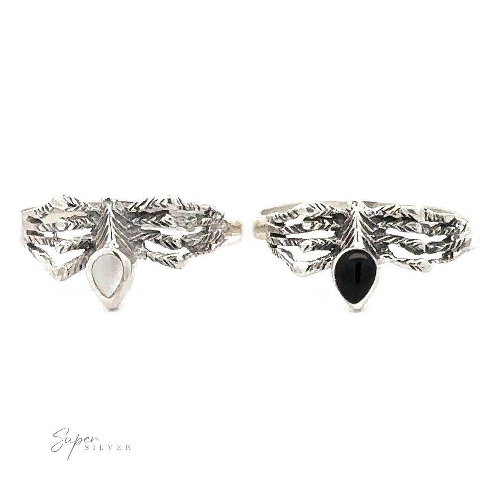 Two Small Inlay Spider Rings: one with a white stone, the other with a black stone. The text 