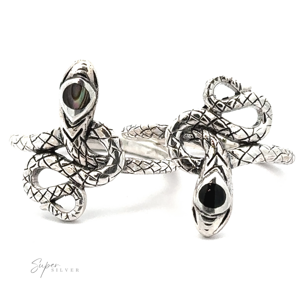 Two intricately designed Coiled Snake Rings with detailed sterling silver scales and black inlaid stones. This transformation jewelry highlights the beauty of the coiled snake ring. Logo text 