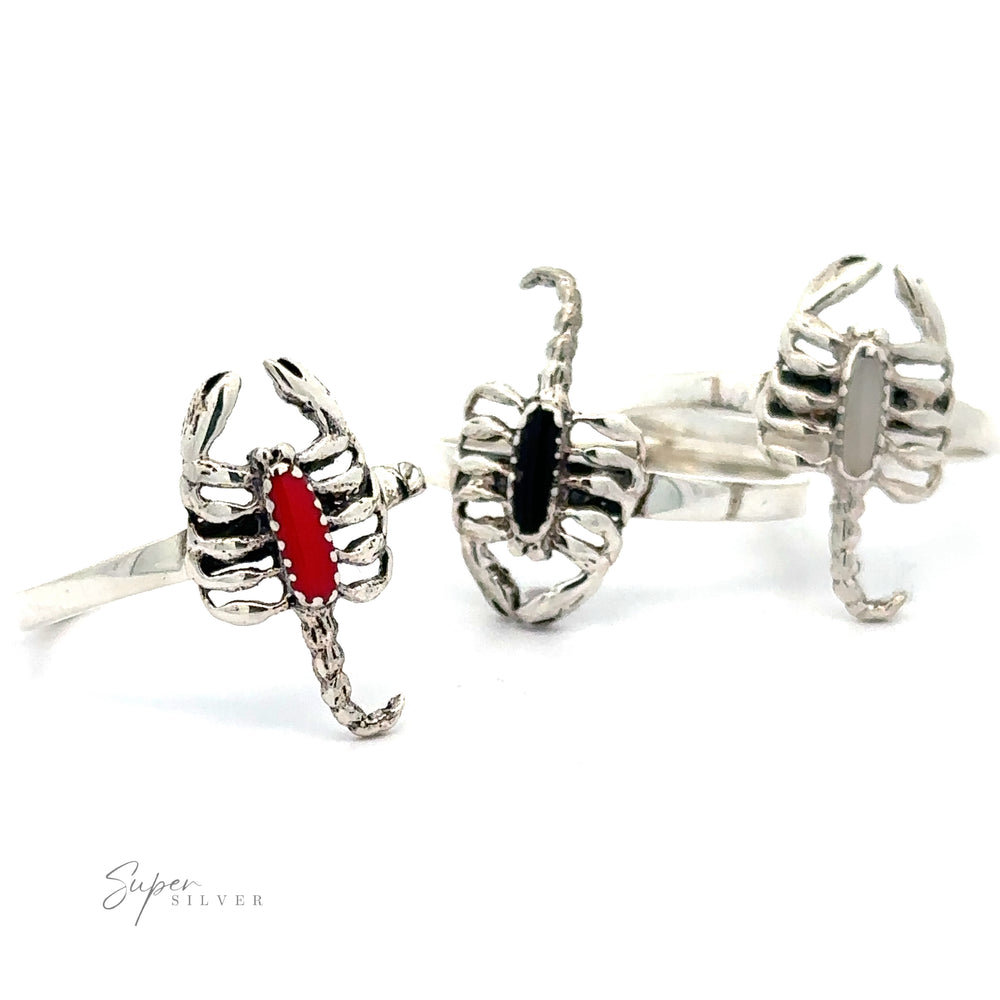 Two Small Scorpion Rings with Red and Black Gemstone accents displayed against a white background.