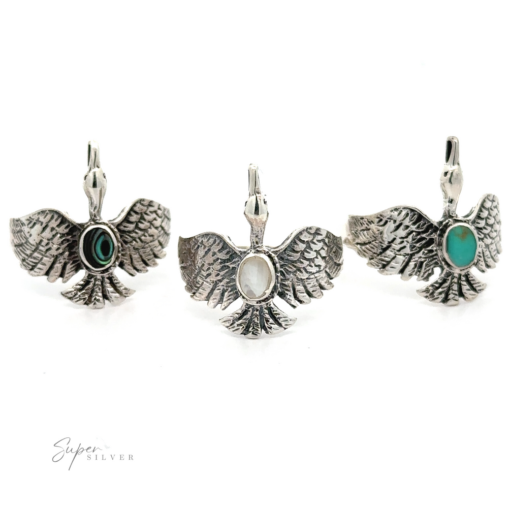 Three sterling silver swan rings with oval turquoise stones.