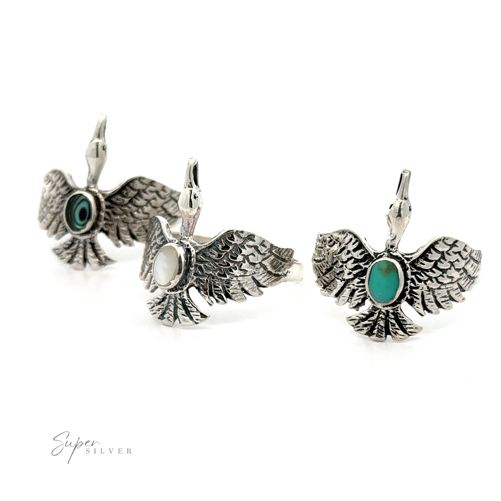 A pair of sterling silver swan earrings with turquoise stones, perfect for the wildlife lover.