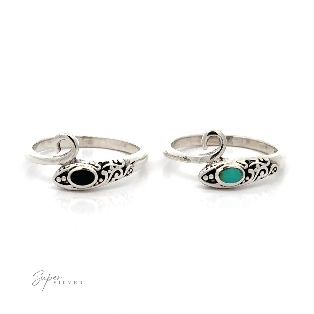 
                  
                    A pair of Inlay Stone Snake Rings with a green stone and filigree designs.
                  
                