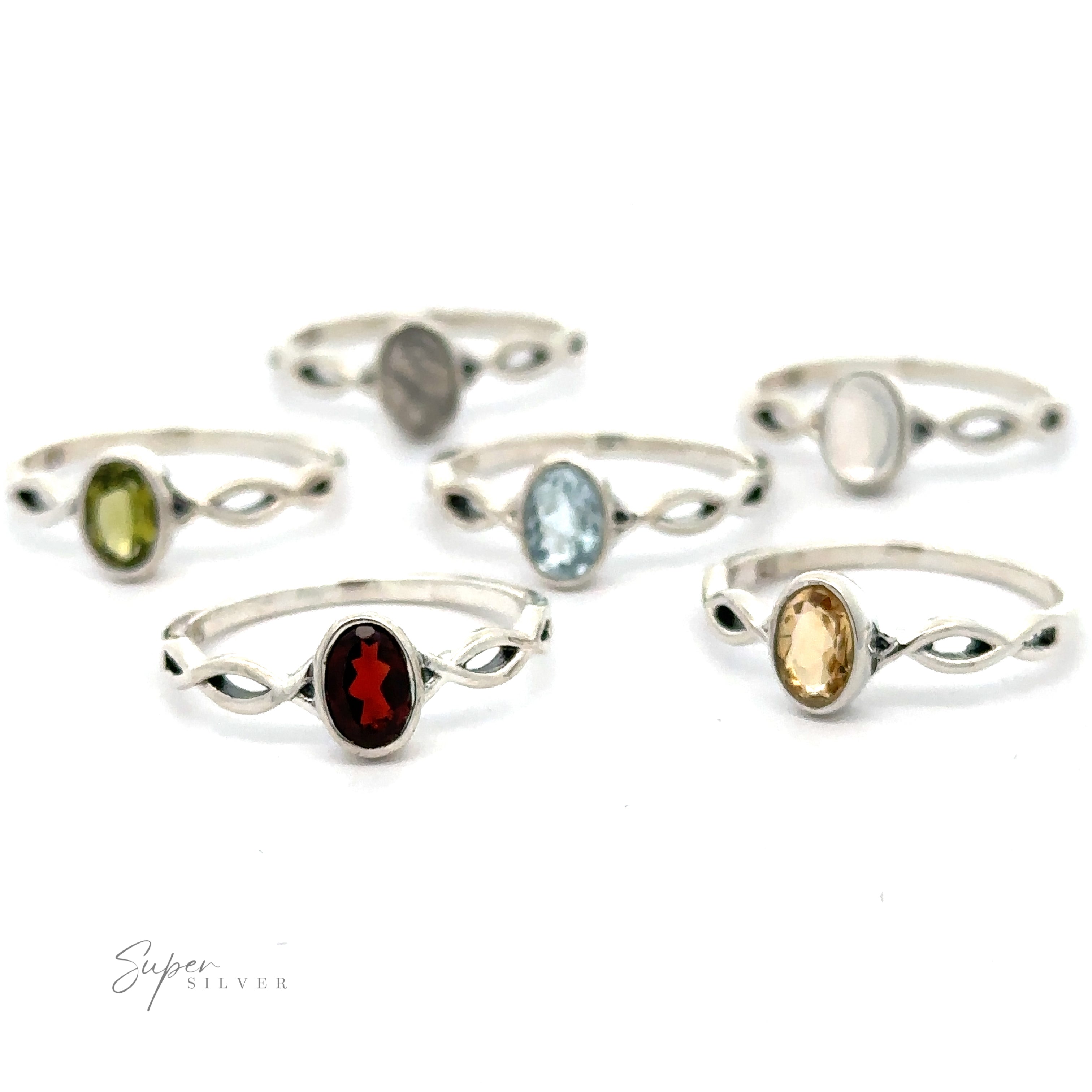 Collection of Dainty Oval Gemstone Rings with Twisted Bands and various colored gemstones on a white background.