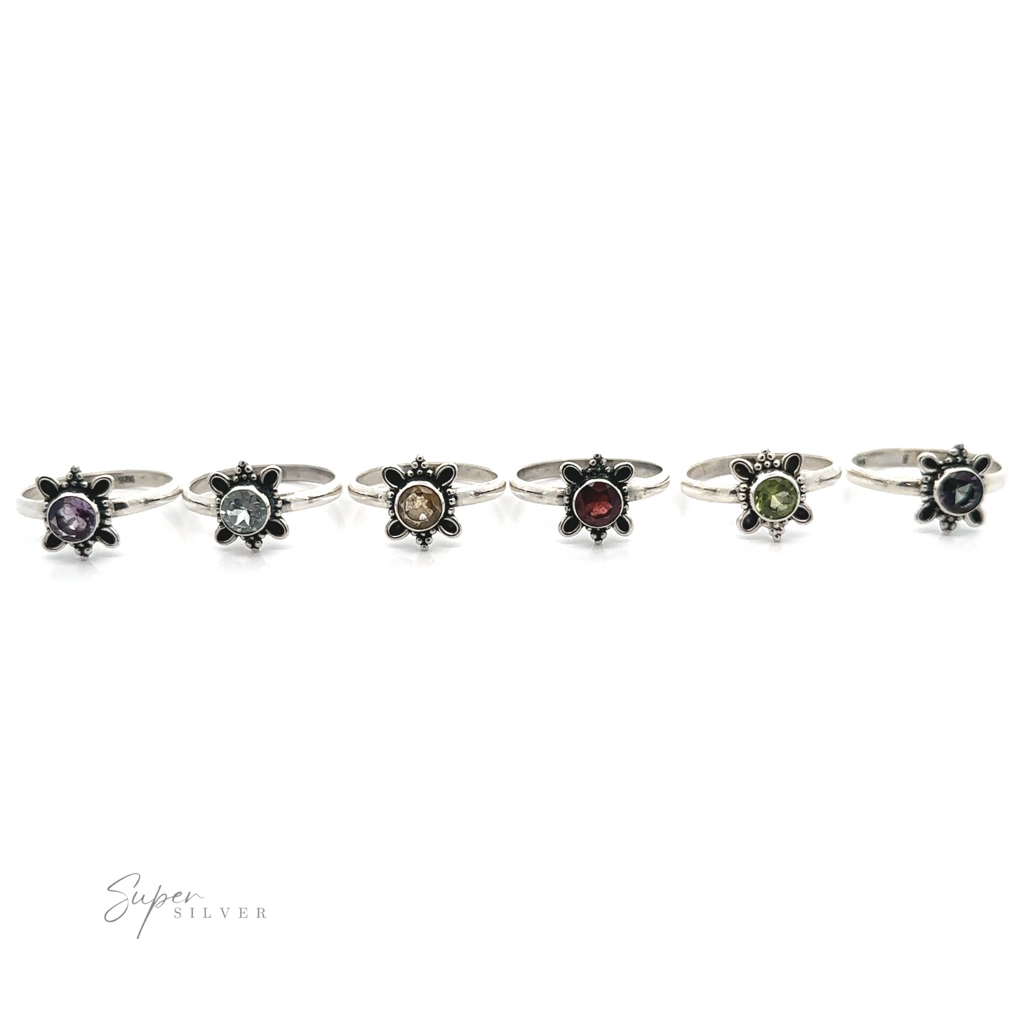 
                  
                    A collection of sterling silver Round Faceted Gemstone Rings with various colored gemstones displayed in a row on a white background.
                  
                
