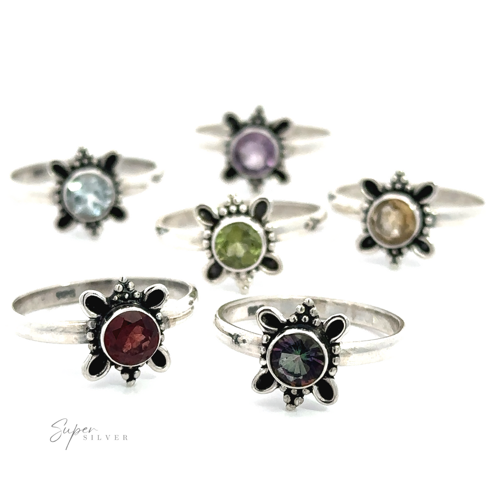 An array of Round Faceted Gemstone Rings with Ball and Loop Design displayed against a white background, perfect for nature lovers.