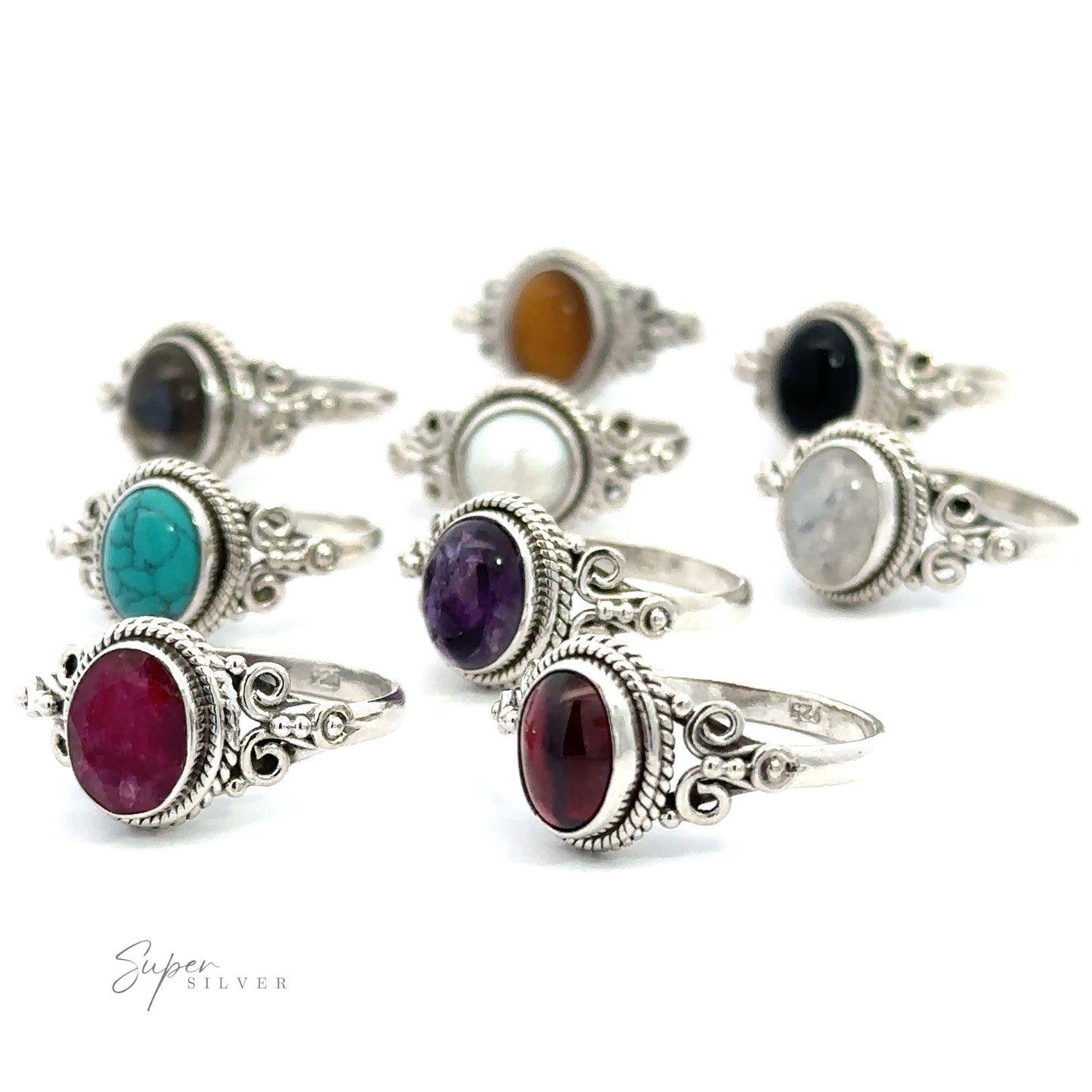 A collection of silver rings with various colored Natural Oval Gemstone Rings with Intricate Rope and Long Spiral Border on a white background.
