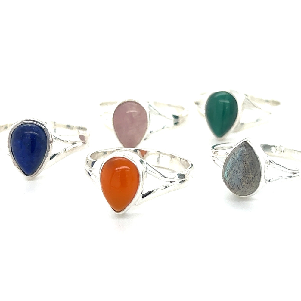 A minimalist set of Simple Teardrop Shape Gemstone rings with different colored stones.
