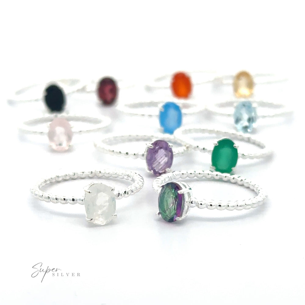 An assortment of Stunning Oval Gemstone Rings with Beaded Bands.