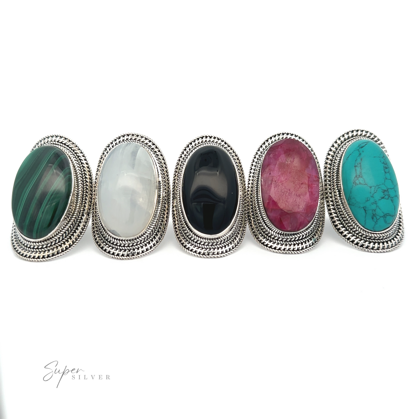 
                  
                    Five Large Oval Shield Gemstone Rings with large oval gemstones in green, white, black, pink, and turquoise set in intricately detailed silver bands are displayed in a row against a white background, exuding a bohemian flair.
                  
                