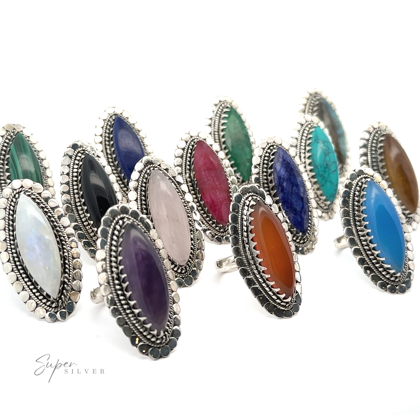 A collection of Statement Marquise Shaped Gemstone Rings with various colored oval gemstones arranged in rows, each piece exuding the charm of Bohemian jewelry.