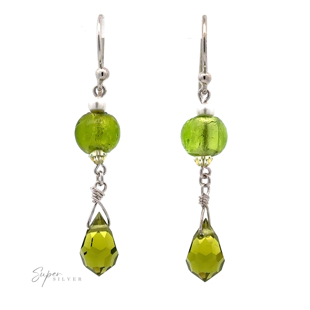 
                  
                    A pair of Dangly Green Beaded Earrings features round green glass beads and teardrop-shaped green crystals. The pieces, adorned with Sterling Silver hooks, are connected by a small silver chain. The text "Super Silver" is in the bottom left corner.
                  
                