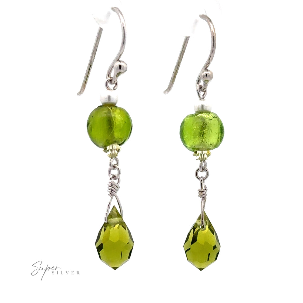 Dangly Green Beaded Earrings featuring glass beads and teardrop-shaped dangles with sterling silver hooks and intricate wire details, displayed on a white background.