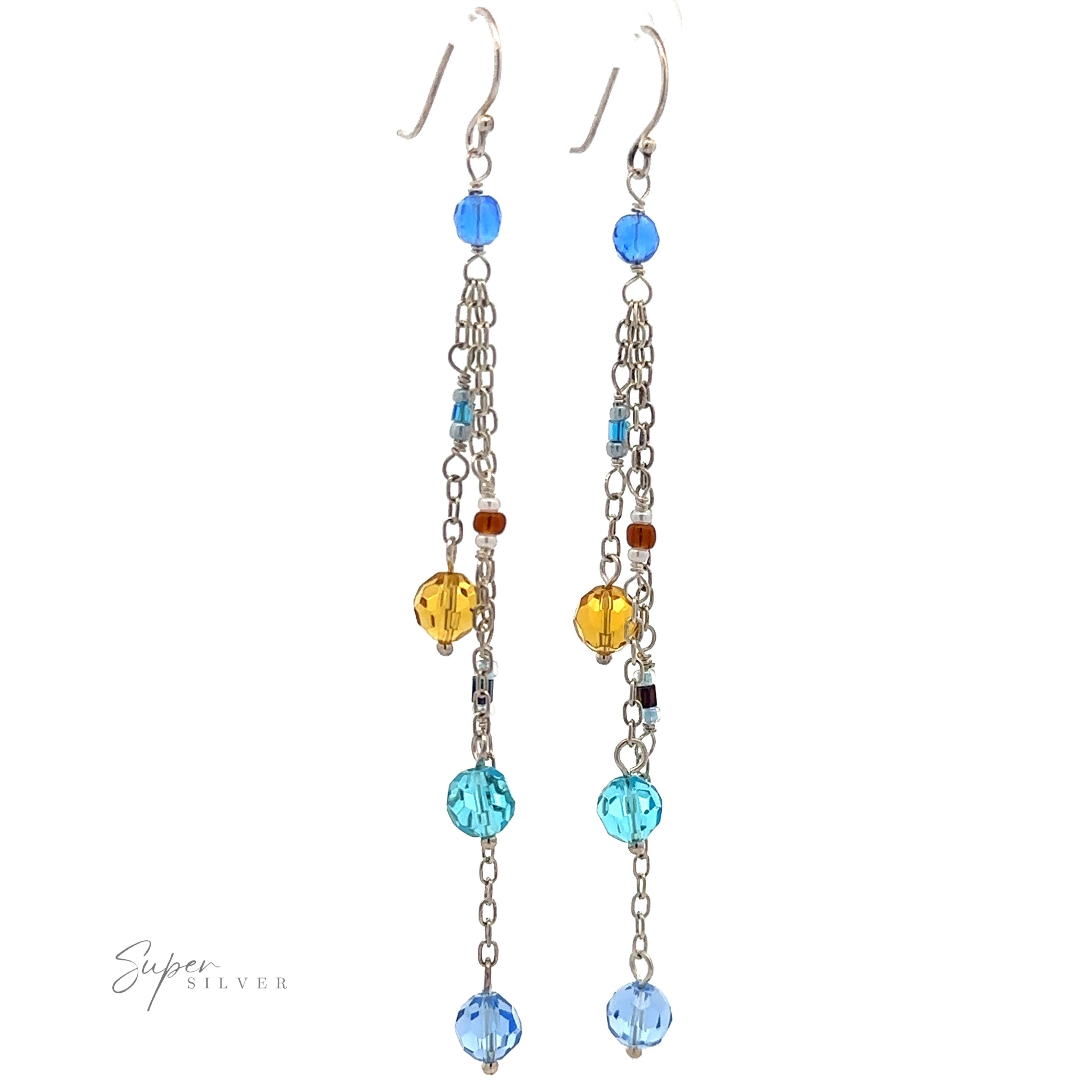 A pair of Multicolor Beaded Dangle Earrings featuring multicolored beads in blue, yellow, and brown, elegantly suspended on sterling silver chains.