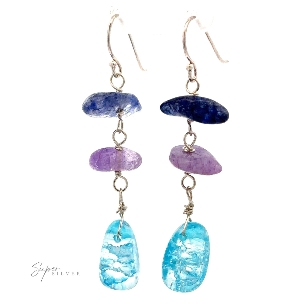 
                  
                    A pair of Beaded Blue and Purple Earrings featuring three stacked stones each: one bright blue bead, one purple bead, and one turquoise stone. The logo "Super Silver" is visible at the bottom left.
                  
                