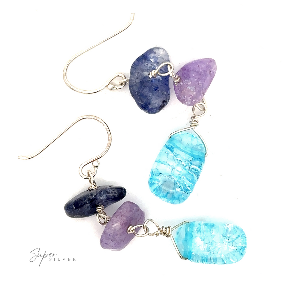 
                  
                    Beaded Blue and Purple Earrings with bright blue beads, purple beads, and clear gemstones, set in sterling silver wire. Hooks are also silver.
                  
                