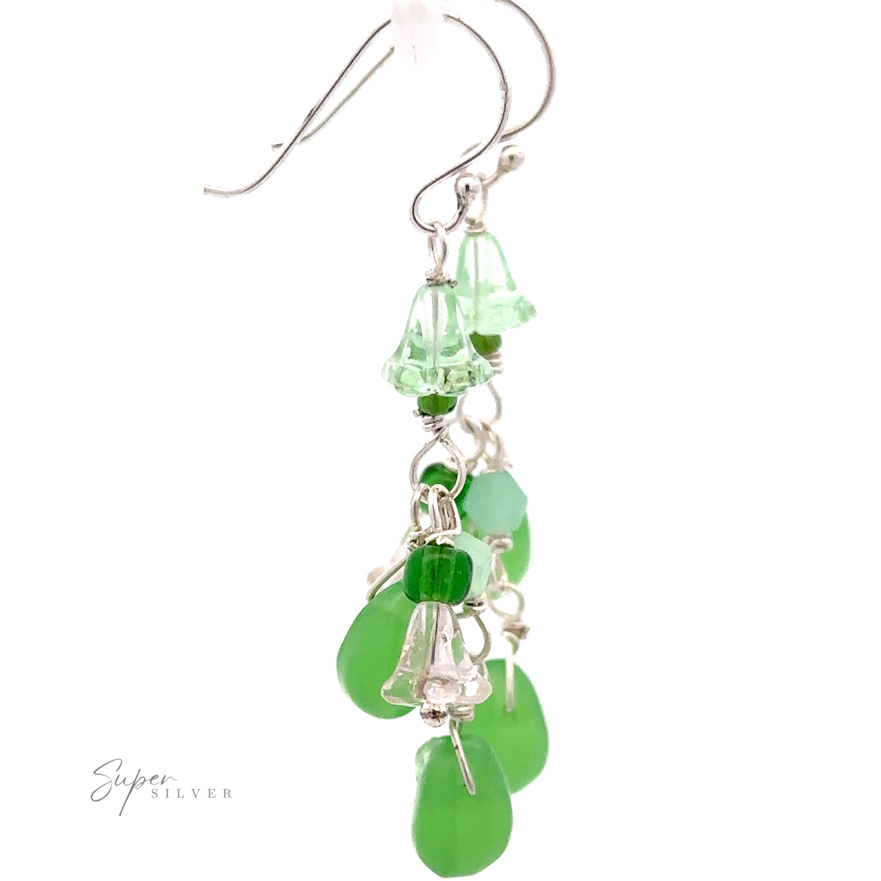 Playful Green Dangle Earrings with multiple green glass bead charms, including translucent bell shapes and opaque teardrops, hanging from a hook.