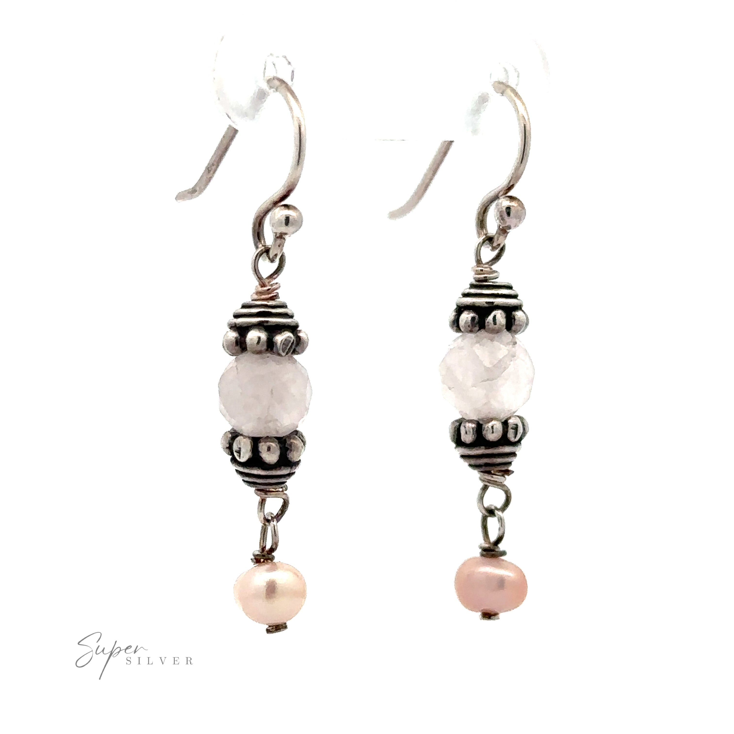 Certainly! Here is the sentence with the product name replaced:

A pair of Beaded Pink and Pearl Earrings featuring a central faceted bead flanked by decorative metal accents and a small pink pearl at the bottom.