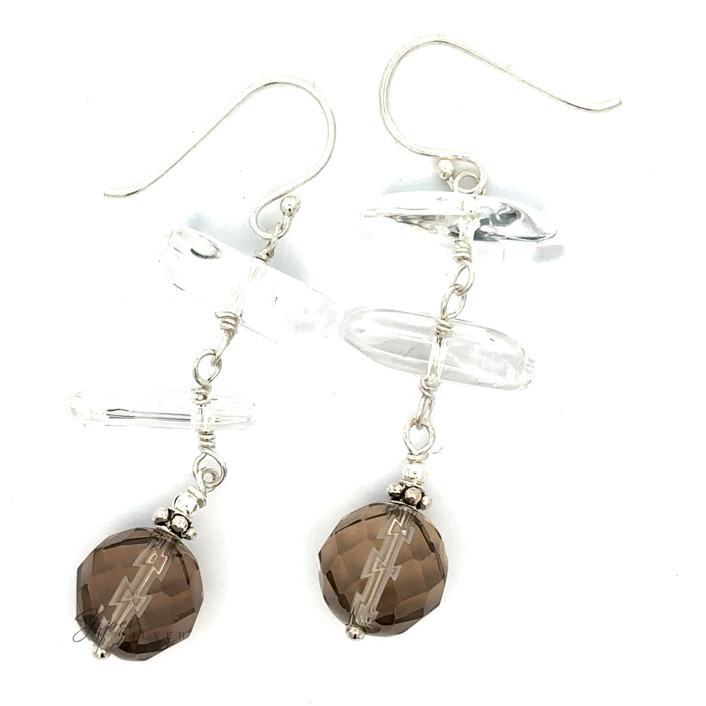 
                  
                    Earrings with Clear and Faceted Gray Beads, featuring sterling silver hooks and intricate wirework.
                  
                
