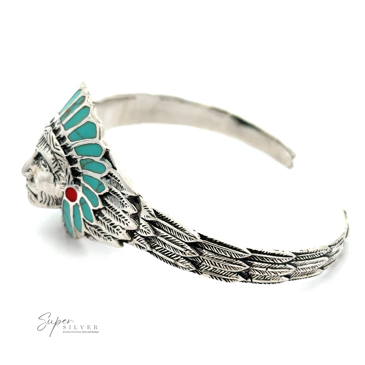 
                  
                    A silver Chief Head Inlay Stone Cuff featuring an intricately carved chief head motif wearing a feathered headdress with turquoise and red accents. The band celebrates Native American heritage with its decorative feather pattern. "Super Silver" logo is visible on the left.
                  
                