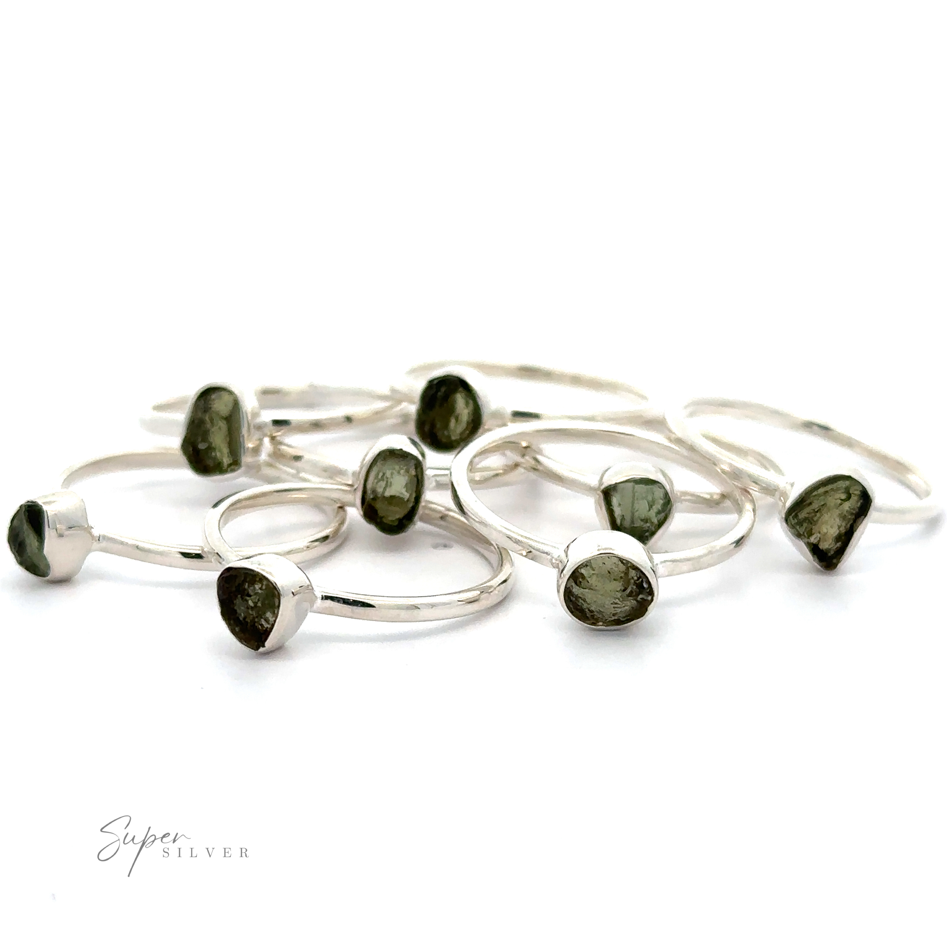 A collection of sterling silver Raw Moldavite Rings, displayed on a white background.