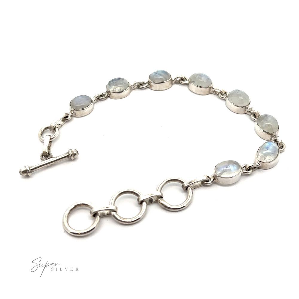A Vibrant Oval Moonstone Bracelet with labradorite stones on it.