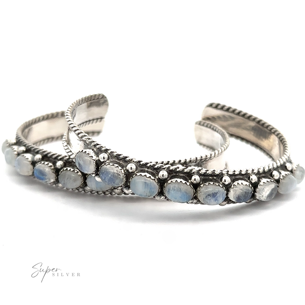 
                  
                    Two intricately designed sterling silver bracelets adorned with blue stones are positioned side by side against a white background. The word "Super Silver" is visible in the lower left corner. These Oval Moonstone Cuff Bracelets are believed to possess unique metaphysical properties.
                  
                