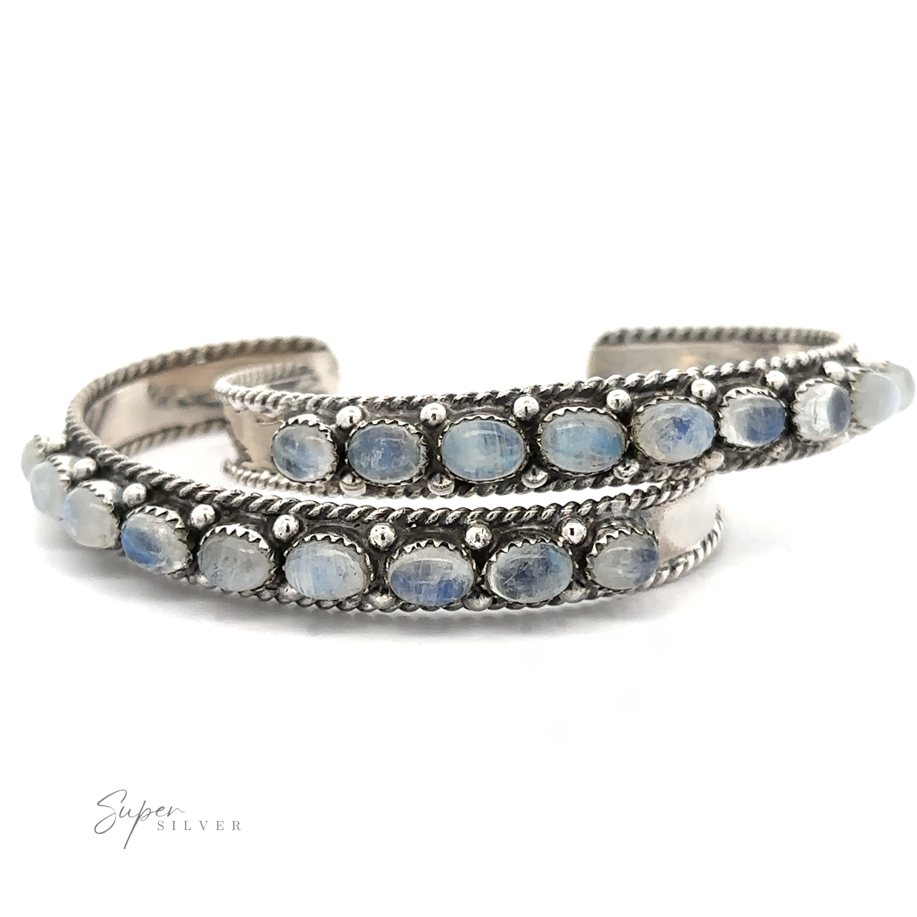 A silver Oval Moonstone Cuff Bracelet with two parallel bands adorned with oval blue stones set in bezels, finished with twisted rope detailing along the edges, believed to aid in emotional healing through its soothing metaphysical properties.