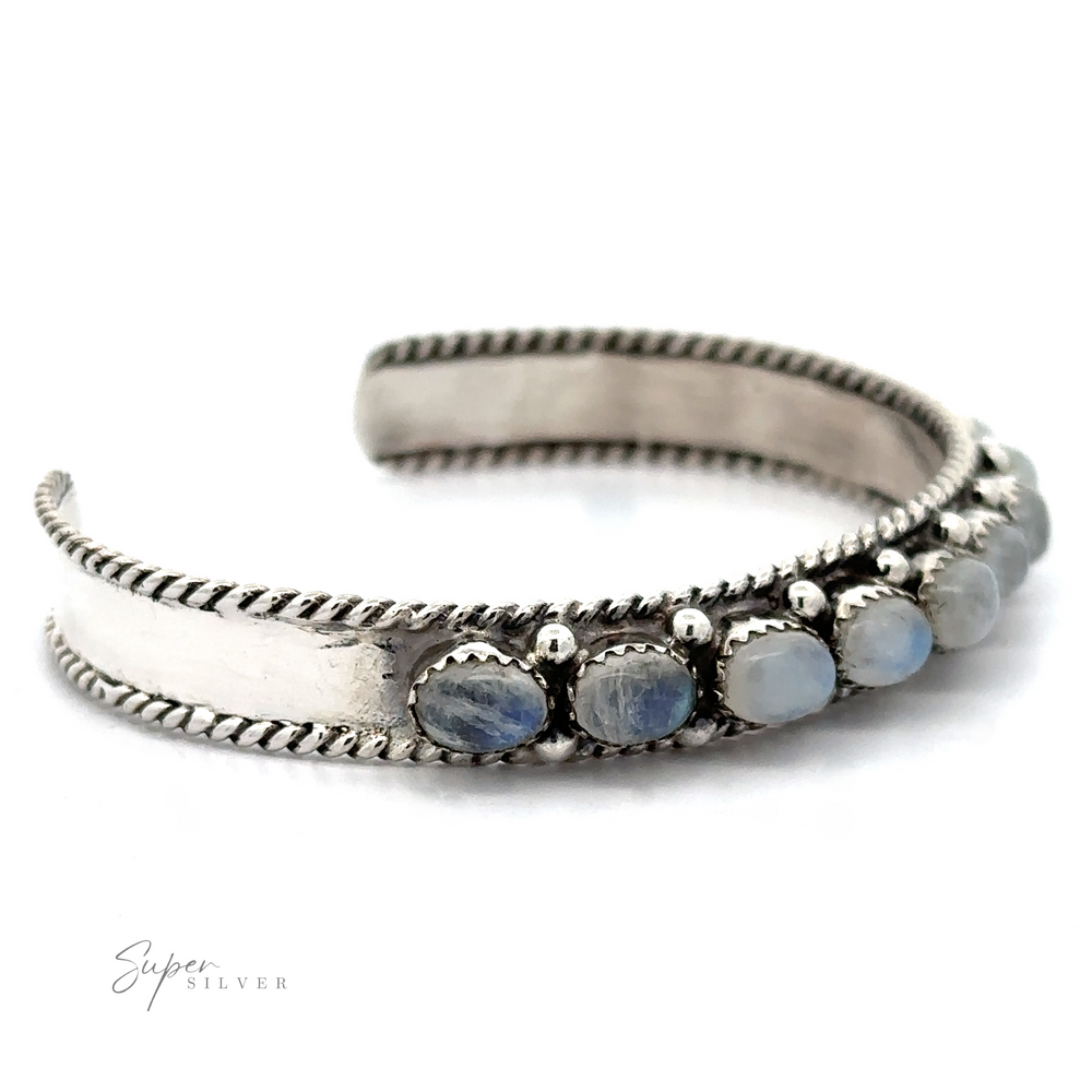 
                  
                    A stunning Oval Moonstone Cuff Bracelet featuring a rope-like edge design and seven oval moonstone beads set in a row, known for their metaphysical properties and emotional healing benefits.
                  
                