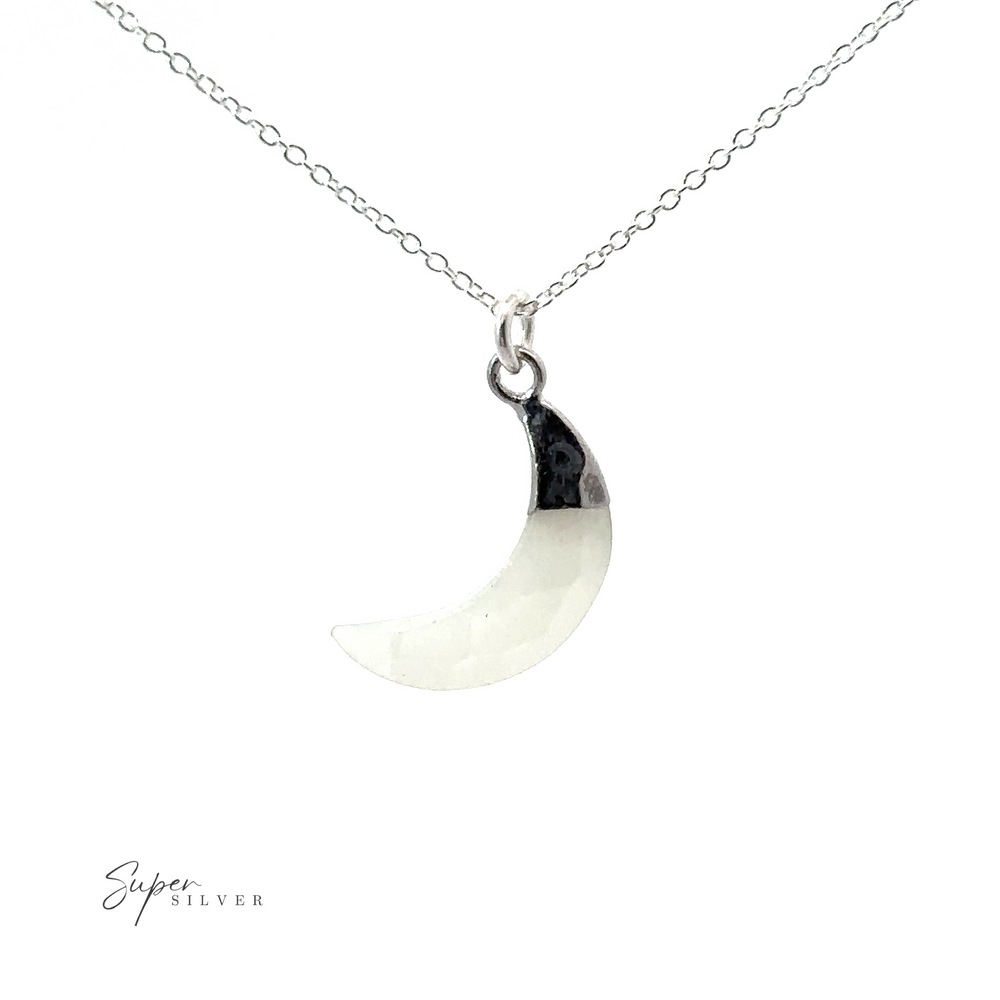 
                  
                    A Delicate Stone Moon Necklace featuring a white crescent moon on a silver chain.
                  
                