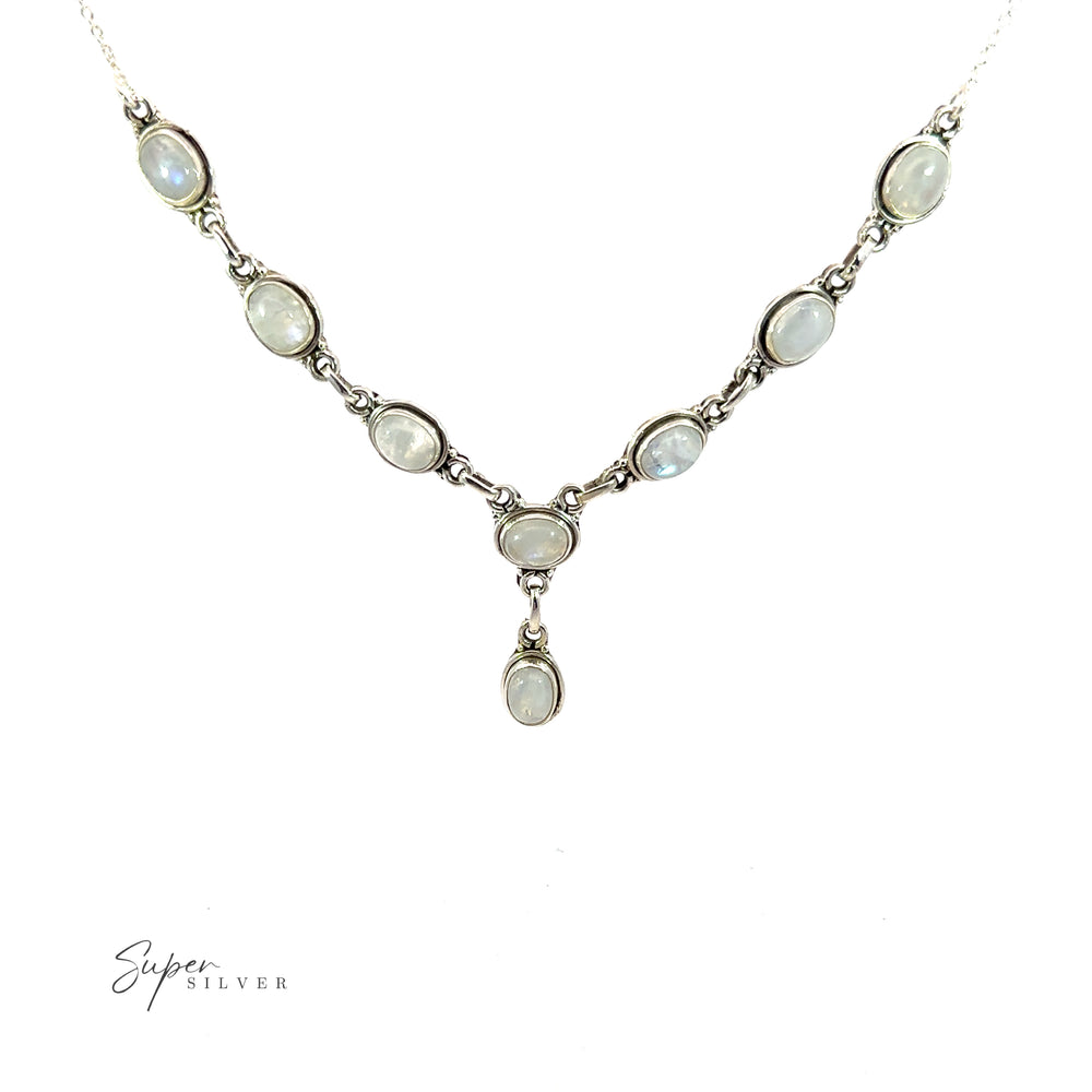 
                  
                    A Simple Oval Y Necklace with Gemstones featuring eight oval moonstone gems, arranged in a symmetrical pattern to exude bohemian charm, with a dangling central moonstone. The text "Super Silver" is visible at the bottom left.
                  
                
