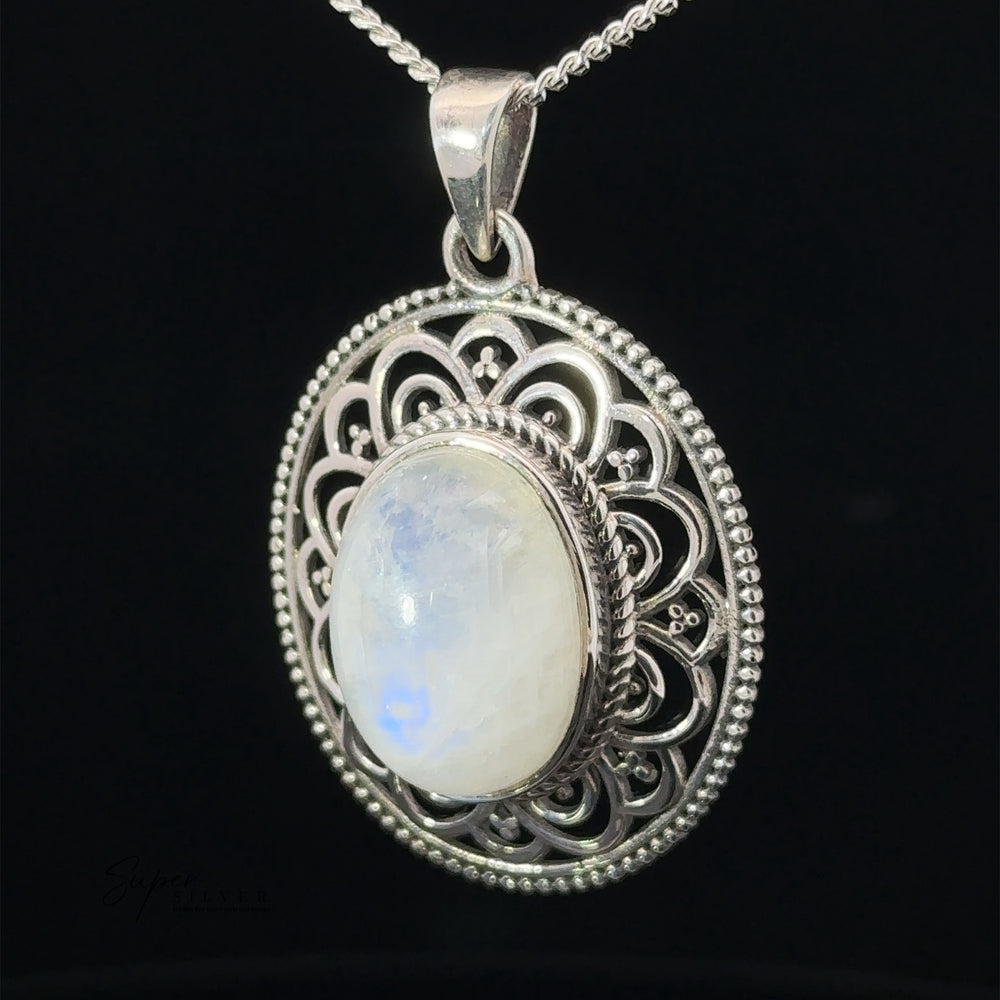 
                  
                    Close-up of an Oval Stone Pendant with Filigree Border, featuring intricate filigree details, hanging on a silver chain against a black background.
                  
                