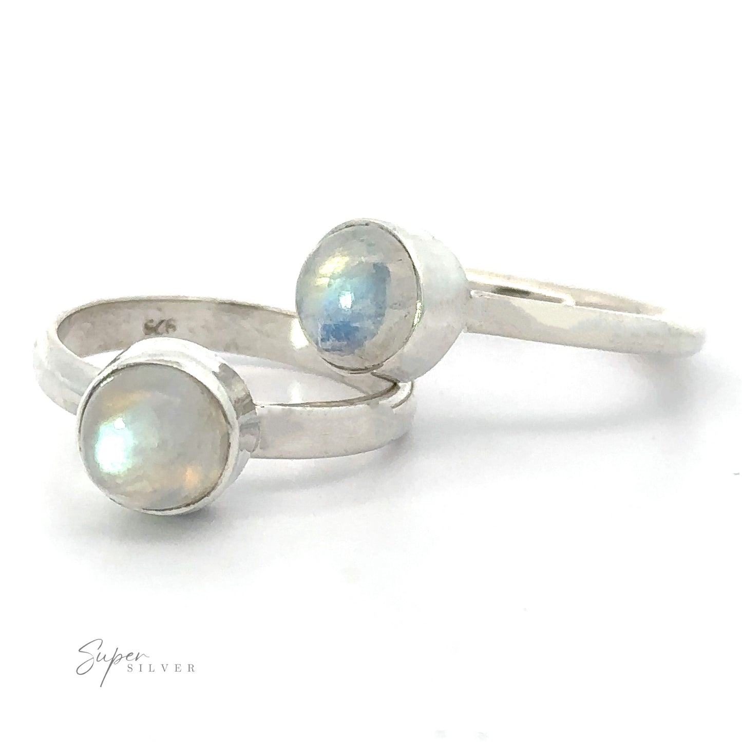 Two Round Moonstone Rings with .925 Sterling Silver bands on a white background.