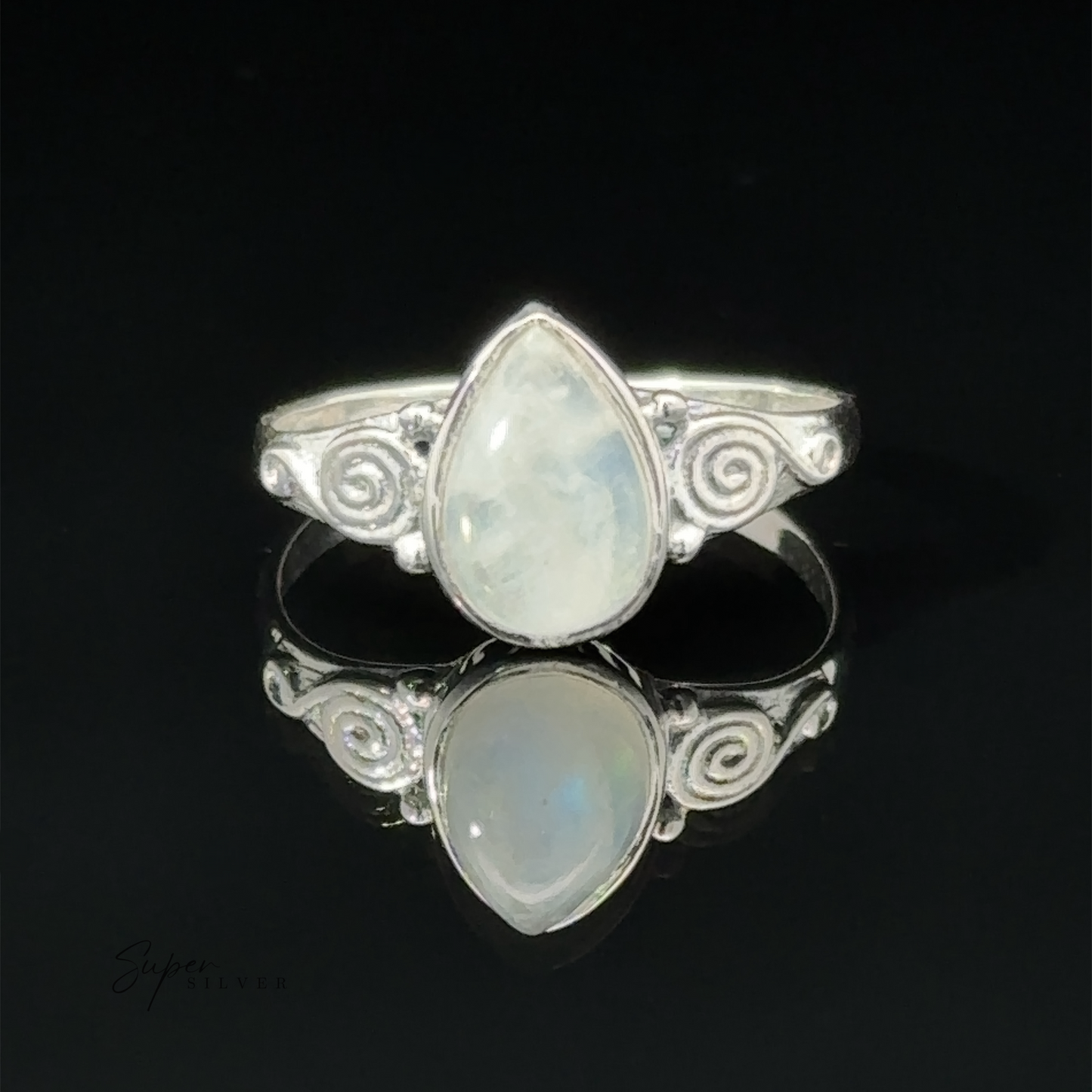 
                  
                    Teardrop Gemstone Ring With Swirls with a teardrop opal set in an intricate design, displayed on a reflective black surface.
                  
                