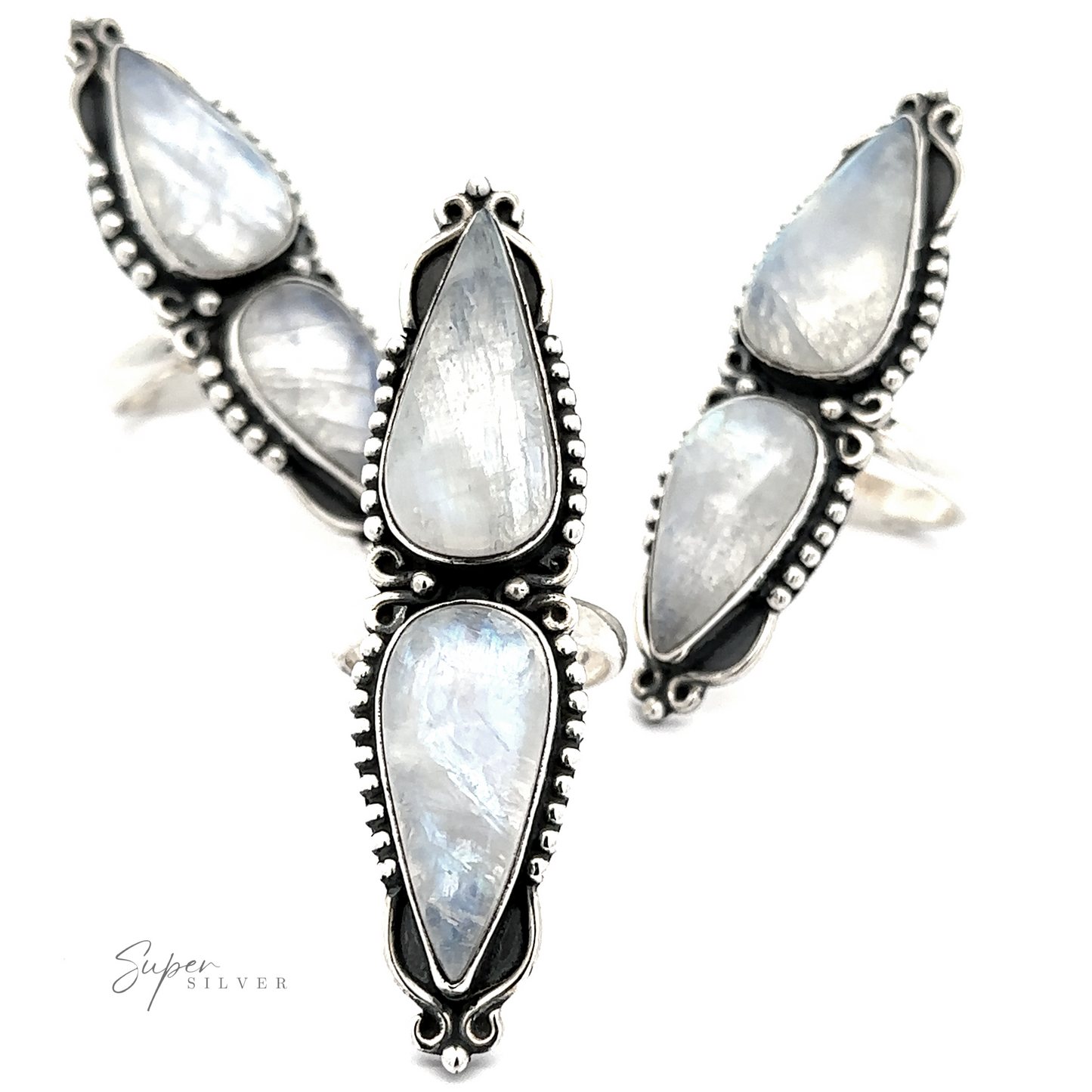 
                  
                    The "Long Double Teardrop Moonstone Ring" by Super Silver is showcased against a white background, featuring four stunning sterling silver rings adorned with teardrop-shaped moonstone gems. Each ring boasts intricate metalwork around the stones, creating a striking statement piece.
                  
                