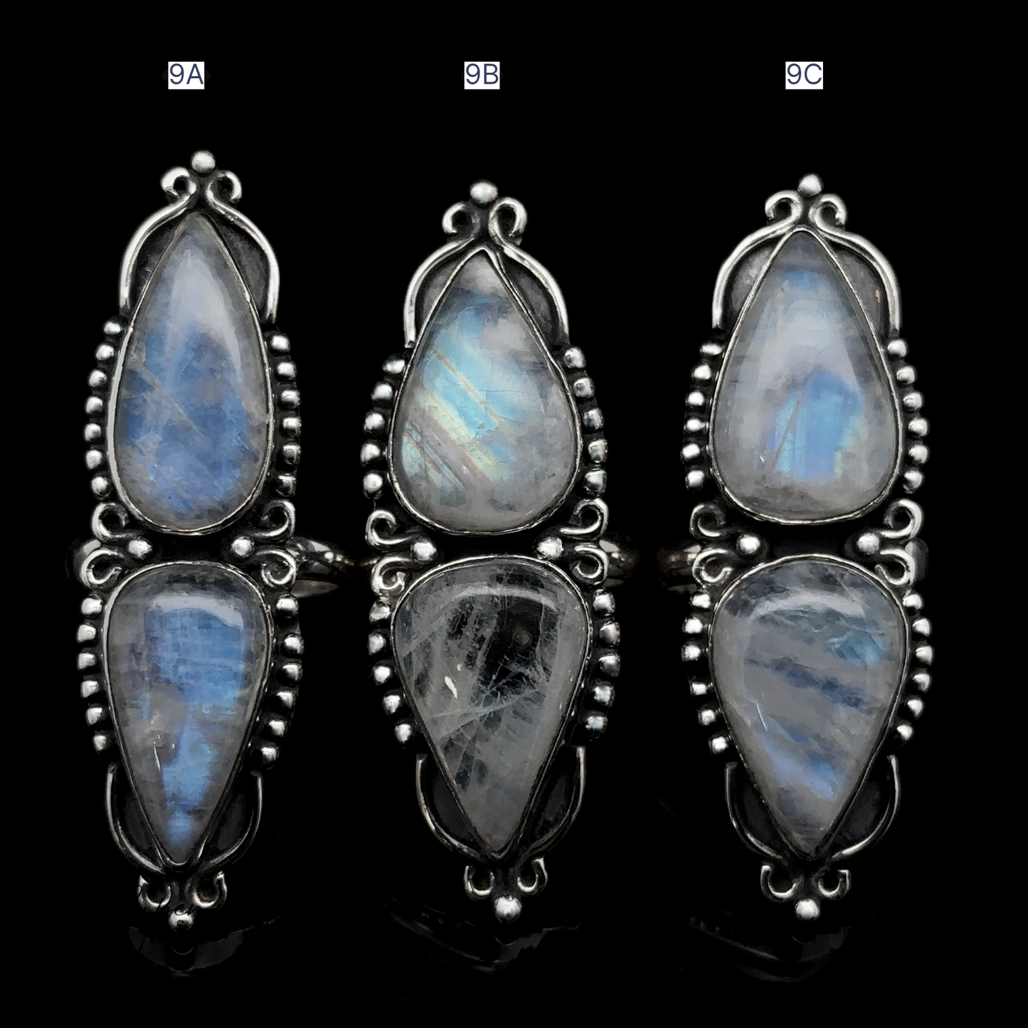 
                  
                    Three Long Double Teardrop Moonstone Rings, labeled 9A, 9B, and 9C, displayed against a black background.
                  
                