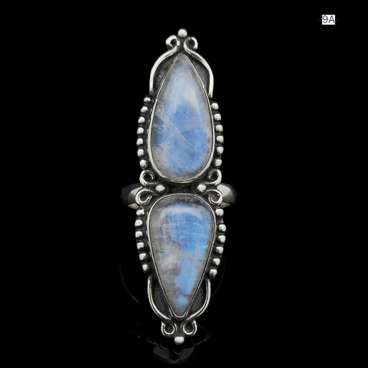 
                  
                    The Long Double Teardrop Moonstone Ring showcases two sizable, teardrop-shaped moonstones set vertically in a sterling silver band adorned with detailed beading.
                  
                