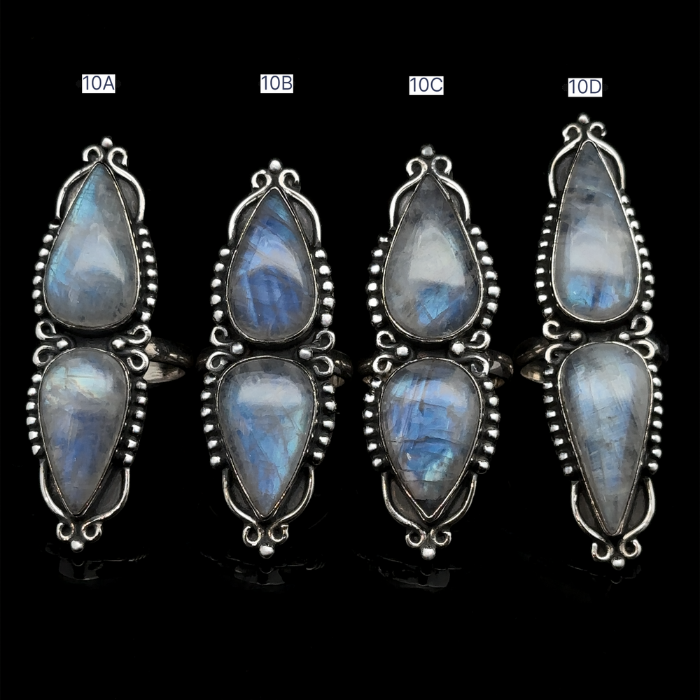 
                  
                    Four pairs of Long Double Teardrop Moonstone Rings, labeled 10A, 10B, 10C, and 10D, displayed vertically against a black background. Each statement ring catches the light beautifully.
                  
                