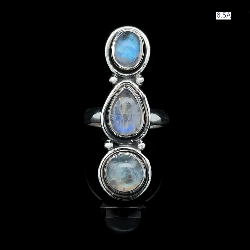 
                  
                    The Triple Moonstone Ring showcases three vertically stacked oval moonstones set against a black background, radiating goddess energy. Elegantly labeled in the top right corner is Size 6.5A.
                  
                